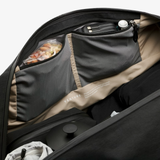 Bellroy Venture Duffel 55L in black, showing spacious main compartment with sturdy handles and sleek design.