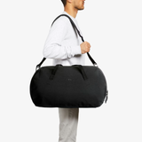 Bellroy Venture Duffel 55L shown in black with sturdy handles and spacious main compartment for travel and daily use.