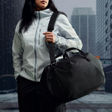 Bellroy Venture Duffel 55L in black, showing spacious design with sturdy handles and adjustable shoulder strap for travel and storage.