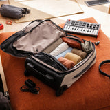 Bellroy Lite Carry-On luggage in ash color, showing its sleek, compact design with a sturdy handle and smooth wheels.