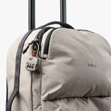 Bellroy Lite Carry-On luggage in ash color, showing its sleek, compact design with sturdy handles and smooth wheels.