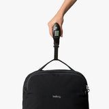 Bellroy Lite Carry-On luggage in ash color, showing sleek carry-on bag with handle and zipper compartments.