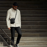 Black Bellroy City Pouch crossbody bag with adjustable strap and multiple compartments, designed for urban use.