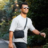 Bellroy Tokyo Side Bag in Raven, a sleek crossbody bag with adjustable strap and modern design, shown from the side.