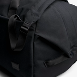 Bellroy Classic Duffel 45L bag in black fabric with handles and adjustable shoulder strap, designed for travel and storage.