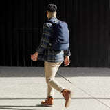 Olive Bellroy Classic Backpack with 20L capacity, featuring multiple compartments and padded shoulder straps for everyday use