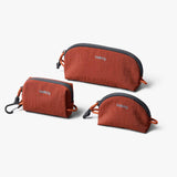 Bellroy Lite Pocket Trio packing organizers in clay color, compact travel pouches for efficient packing and organization.
