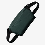 Bellroy Venture Sling 9L in navy blue, showing its compact design with adjustable strap and front zipper pocket.
