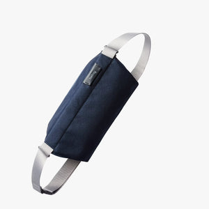 Bellroy Sling Mini in black with adjustable strap, compact design, and sleek zipper closure on front pocket.