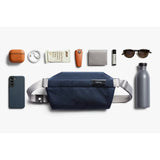 Bellroy Sling Mini in black with adjustable strap, compact design, and multiple zipper compartments for versatile everyday use.