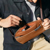 Bellroy Sling Mini compact sling bag with adjustable strap and multiple compartments for everyday essentials.