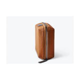 Bellroy Tech Kit Compact in black, showing a sleek, organized tech storage pouch with multiple compartments for cables and accessories.