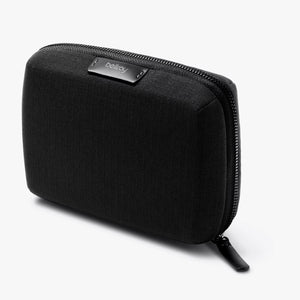 Bellroy Tech Kit Compact in black, a sleek travel organizer with multiple compartments for tech accessories and cables.
