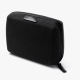 Bellroy Tech Kit Compact in black, a sleek travel organizer with multiple compartments for tech accessories and cables.