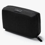 Bellroy Tech Kit with multiple compartments for organizing cables, chargers, and accessories in a sleek, compact design.
