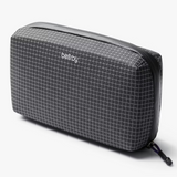 Bellroy Tech Kit showing organized compartments with cables, chargers, and accessories in a sleek, compact design.