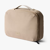 Bellroy Hanging Toiletry Kit Plus in stone color, showcasing a compact, organized toiletry bag with hanging hook and multiple compartments.