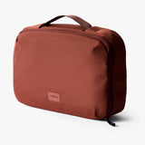 Bellroy Hanging Toiletry Kit Plus in stone, showing its compact design, hanging hook, and multiple compartments for travel essentials.