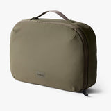 Bellroy Hanging Toiletry Kit Plus in stone color, featuring multiple compartments and a hanging design for travel organization.