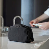 Bellroy toiletry kit in clay color with multiple compartments and zipper closure, designed for organizing travel toiletries.