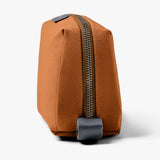 Bellroy toiletry kit in clay color showing compact, organized design with zipper closure and multiple interior compartments.