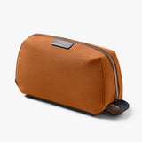 Bellroy toiletry kit in clay color, compact travel organizer with multiple compartments for toiletries and grooming essentials.