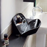 Bellroy Toiletry Kit Plus in clay color with multiple compartments and sleek design for organizing travel essentials.