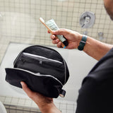 Bellroy Toiletry Kit Plus in clay, a compact travel toiletry bag with multiple compartments for toiletries and grooming essentials.