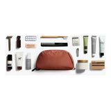 Bellroy Toiletry Kit Plus in clay with multiple compartments and waterproof zipper, designed for organization and travel convenience.