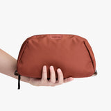 Bellroy Toiletry Kit Plus in clay, compact travel toiletry bag with multiple compartments for toiletries and grooming essentials.