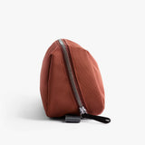 Bellroy Toiletry Kit Plus in clay color, compact travel toiletry bag with multiple compartments for personal care essentials.