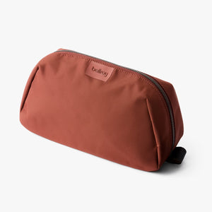 Bellroy Toiletry Kit Plus in clay, compact travel toiletry bag with multiple compartments for toiletries and personal items.