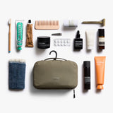 Bellroy hanging toiletry kit in sea kelp color, showing compact design with multiple compartments for travel essentials.