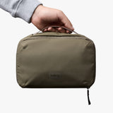Bellroy Hanging Toiletry Kit in Sea Kelp color with multiple compartments and hanging hook for organized travel storage.