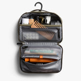 Bellroy hanging toiletry kit in sea kelp color with multiple compartments and a hanging hook for travel organization.