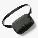 Black Bellroy Transit Sling 5L waist pack with adjustable strap, compact design, ideal for carrying essentials comfortably.