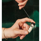 Bite Floss, a dental floss product with white and mint-colored string, designed for effective interdental cleaning.