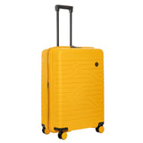 Bric's B|Y Ulisse 27.5-inch expandable luggage spinner with hard shell, four wheels, and telescoping handle for travel.