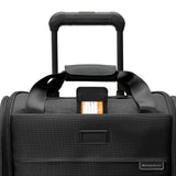 Blue Briggs & Riley Baseline Cabin Spinner carry-on luggage with four wheels and telescopic handle for easy travel.