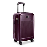 Briggs & Riley Sympatico Essential 22-inch plum carry-on luggage with expandable spinner wheels and sleek hard-shell design.