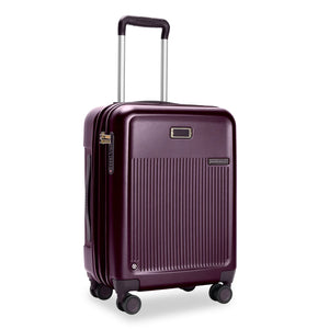 Briggs & Riley Sympatico global carry-on expandable spinner luggage in plum with four wheels and telescoping handle.