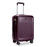 Briggs & Riley Sympatico global carry-on expandable spinner luggage in plum with four wheels and telescoping handle.