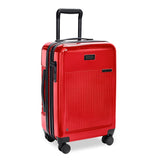 Briggs & Riley Sympatico Essential Carry-On Spinner in glossy ruby red with four wheels and telescoping handle.