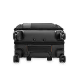 Briggs & Riley ZDX Essential Carry-On Expandable Spinner luggage with four wheels and a hard shell, shown from the bottom angle.