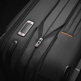 Briggs & Riley ZDX Essential Carry-On Expandable Spinner luggage with four wheels and sleek black design, front view.