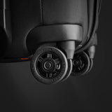Briggs & Riley ZDX Essential Carry-On Expandable Spinner luggage with four wheels and sleek black design, front view.