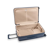 Black Briggs & Riley Sympatico large expandable checked luggage spinner with four wheels and a telescoping handle.