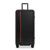 Black Briggs & Riley ZDX extra large 32-inch hardside checked luggage with spinner wheels and secure handle.