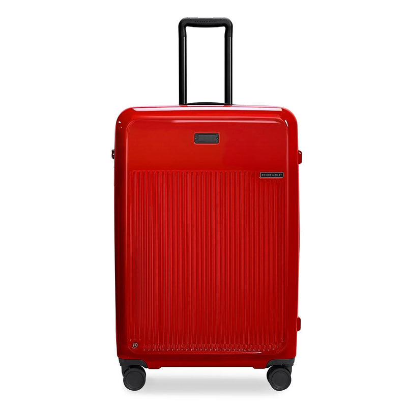 Briggs & Riley Sympatico large expandable spinner checked luggage in glossy ruby red with four wheels and a sleek design.
