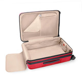 Briggs & Riley Sympatico medium expandable spinner checked luggage in glossy ruby red with four wheels and a sturdy handle.